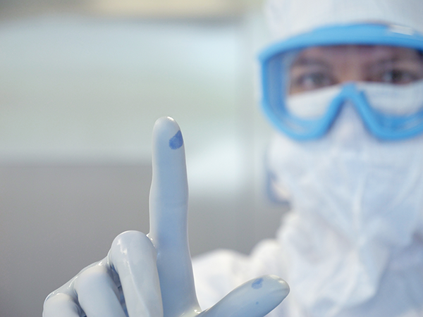 Scientist showing finger tips with gloves on